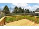 A wooden deck overlooking the backyard with a wood fence and several trees at 12455 Deerview Dr, Noblesville, IN 46060