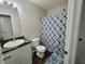 Cozy bathroom featuring a marbled countertop, modern fixtures, and a stylish blue shower curtain at 1336 Danielle Rd, Lebanon, IN 46052