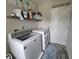 Bright laundry room featuring modern washing machine and dryer set with convenient overhead shelving at 1336 Danielle Rd, Lebanon, IN 46052