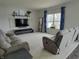 Comfortable living room featuring neutral tones, a plush sofa, and a large window at 1336 Danielle Rd, Lebanon, IN 46052