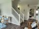 Open-concept living area featuring hardwood floors, a staircase, and comfortable furnishings at 1336 Danielle Rd, Lebanon, IN 46052