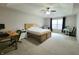 Spacious main bedroom with a tray ceiling, ceiling fan, carpeted floors, and large windows for natural light at 1336 Danielle Rd, Lebanon, IN 46052