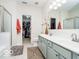 Bright bathroom with double vanity sinks, a separate shower, and a walk-in closet at 13921 Leatherwood Dr, Carmel, IN 46033