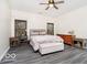 Well-lit bedroom with hardwood floors, a comfortable bed, and ample natural light at 13921 Leatherwood Dr, Carmel, IN 46033