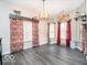Inviting dining room with natural light, modern light fixture, and stylish window treatments at 13921 Leatherwood Dr, Carmel, IN 46033