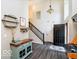 Welcoming foyer with hardwood floors, a stylish console table, and an open staircase to the upper level at 13921 Leatherwood Dr, Carmel, IN 46033