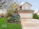 Charming two-story home with a brick facade, two car garage, and a well-manicured lawn at 13921 Leatherwood Dr, Carmel, IN 46033