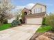Two-story home with a two-car garage, brick accents, and a spacious driveway at 13921 Leatherwood Dr, Carmel, IN 46033