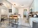 Open-concept kitchen with a breakfast bar, stainless appliances, and stylish flooring at 13921 Leatherwood Dr, Carmel, IN 46033