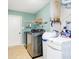 Well-equipped laundry room with modern washer, dryer, and ample shelving at 13921 Leatherwood Dr, Carmel, IN 46033