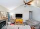 Bright living area with a modern ceiling fan, cozy furniture, and a decorative fireplace at 13921 Leatherwood Dr, Carmel, IN 46033