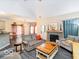 Cozy living room with a decorative fireplace, comfortable seating, and lots of natural light at 13921 Leatherwood Dr, Carmel, IN 46033