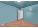 Empty bedroom showcasing hardwood floors and walls painted in a pleasant blue hue at 1441 N Euclid Ave, Indianapolis, IN 46201