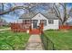 Charming one story home with a small front porch and a well-maintained lawn at 1441 N Euclid Ave, Indianapolis, IN 46201