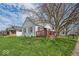 Charming home with a red deck, mature trees, and a well-manicured lawn at 1441 N Euclid Ave, Indianapolis, IN 46201