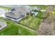 Aerial view of a blue two-story home featuring an in-ground pool and lush lawn near a serene lake at 14918 Dawnhaven Dr, Westfield, IN 46074