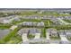 Wide aerial view showing the blue home in a neighborhood with a pond and a green common area at 14918 Dawnhaven Dr, Westfield, IN 46074