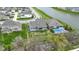 An aerial view showcasing the home's well-manicured lawn and in-ground pool near a beautiful pond at 14918 Dawnhaven Dr, Westfield, IN 46074