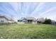 Large backyard featuring a well-maintained lawn, mature trees, and a home exterior at 14918 Dawnhaven Dr, Westfield, IN 46074