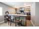 Custom wet bar featuring a metallic backsplash, open shelving, and ample counter space at 14918 Dawnhaven Dr, Westfield, IN 46074