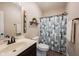 Well-lit bathroom features updated sink and vanity alongside a patterned shower curtain at 14918 Dawnhaven Dr, Westfield, IN 46074