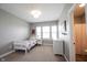 Bright bedroom with natural light, featuring a twin bed, dresser, and ensuite bathroom at 14918 Dawnhaven Dr, Westfield, IN 46074