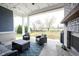 Relaxing covered patio with outdoor furniture, a fireplace, and a view of the lush backyard at 14918 Dawnhaven Dr, Westfield, IN 46074