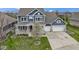 Beautiful two-story home boasting a two-car garage, covered porch, mature landscaping, and blue siding at 14918 Dawnhaven Dr, Westfield, IN 46074