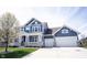 Stylish home featuring a covered front porch, a two-car garage, concrete driveway, blue siding, and tidy landscaping at 14918 Dawnhaven Dr, Westfield, IN 46074