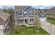 Attractive home showcasing a two-car garage, covered porch, green lawn, landscaped beds, and blue siding at 14918 Dawnhaven Dr, Westfield, IN 46074