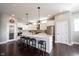 Modern kitchen with a granite-topped island, stainless appliances, white cabinetry, and hardwood floors at 14918 Dawnhaven Dr, Westfield, IN 46074