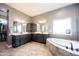 Main bathroom with double vanity, soaking tub, and modern finishes at 14918 Dawnhaven Dr, Westfield, IN 46074