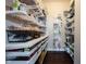 Organized walk-in pantry with ample shelving, pull out drawers and wood floors at 14918 Dawnhaven Dr, Westfield, IN 46074