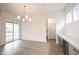 Bright dining space with sliding glass doors, a modern chandelier, and a convenient beverage fridge at 15109 Larchwood Dr, Westfield, IN 46074