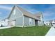 Exterior of a two-story home with a blue-gray siding, lawn, and an attached garage at 15109 Larchwood Dr, Westfield, IN 46074