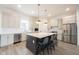 Bright kitchen featuring a large island with bar seating, stainless steel appliances, and modern finishes at 15109 Larchwood Dr, Westfield, IN 46074