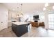 Open-concept kitchen with stainless steel appliances, a large island, and seamless transition to the living area at 15109 Larchwood Dr, Westfield, IN 46074