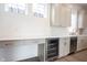 Stylish kitchenette with a beverage fridge, sleek countertops, and ample storage at 15109 Larchwood Dr, Westfield, IN 46074