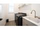 A laundry room with newer appliances, a sink and shelving at 15109 Larchwood Dr, Westfield, IN 46074