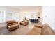 Open-concept living space with a large kitchen island, leather seating, and plenty of natural light at 15109 Larchwood Dr, Westfield, IN 46074