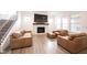 Inviting living room with a modern fireplace, leather furniture, and a view of the staircase at 15109 Larchwood Dr, Westfield, IN 46074