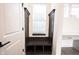 A mudroom with dark brown wood storage bench and hooks at 15109 Larchwood Dr, Westfield, IN 46074