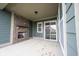 Covered patio with brick fireplace, sliding glass door, and green siding at 15109 Larchwood Dr, Westfield, IN 46074
