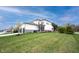 Expansive backyard showing the house with a large manicured lawn, ideal for outdoor activities and relaxation at 15591 Heatherbank Dr, Westfield, IN 46074