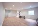 Open basement space with hardwood flooring and natural light, versatile for various uses, like recreation or storage at 15591 Heatherbank Dr, Westfield, IN 46074
