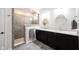 Modern bathroom with double vanity, sleek cabinets, and a tiled walk-in shower at 15591 Heatherbank Dr, Westfield, IN 46074