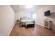 Finished bedroom featuring modern laminate floors, a metal frame bed, a window, and bedside tables at 15591 Heatherbank Dr, Westfield, IN 46074