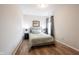Neutral bedroom showcasing hardwood floors, a comfortable bed, and natural light creating a serene atmosphere at 15591 Heatherbank Dr, Westfield, IN 46074
