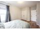 Well-lit bedroom with hardwood floors, closet, and window offers a relaxing space at 15591 Heatherbank Dr, Westfield, IN 46074