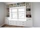 Custom built-in shelving and drawers surrounding a window seat, offering ample storage and display space at 15591 Heatherbank Dr, Westfield, IN 46074